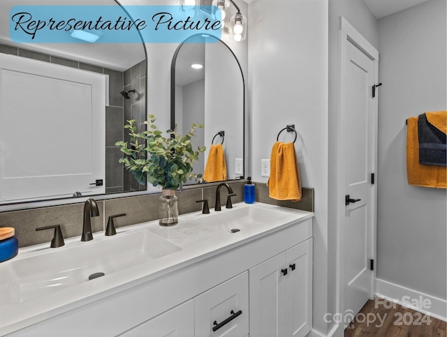 bathroom with hardwood / wood-style flooring and double sink vanity