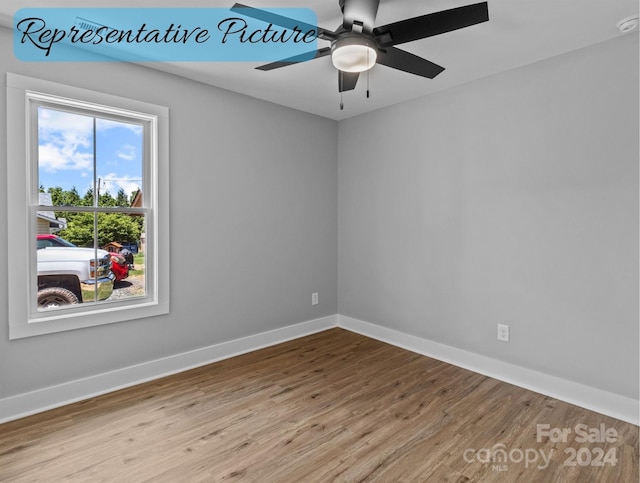 empty room with ceiling fan and light wood-type flooring