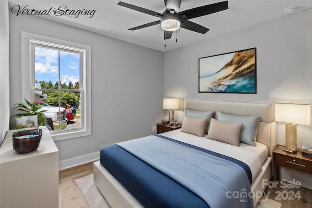 bedroom with ceiling fan and light hardwood / wood-style floors