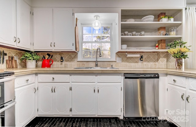 kitchen featuring white cabinetry, appliances with stainless steel finishes, light countertops, and a sink