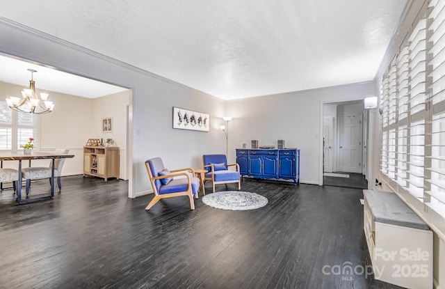 living area featuring dark wood-style floors and an inviting chandelier