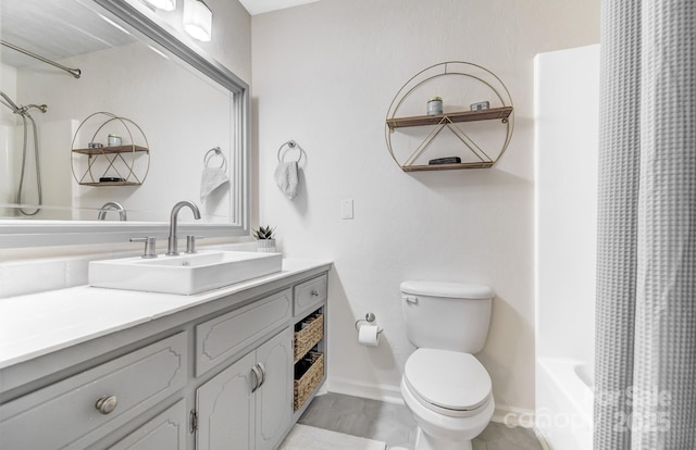 full bathroom with toilet, shower / tub combo, baseboards, and vanity