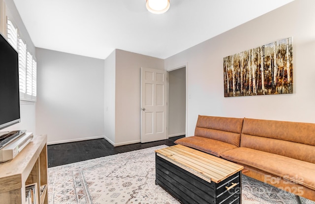 living room featuring dark wood-style flooring and baseboards