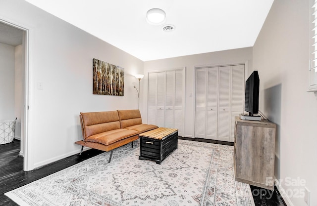 living room with baseboards and visible vents