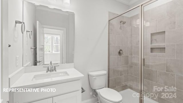 bathroom featuring walk in shower, vanity, toilet, and crown molding