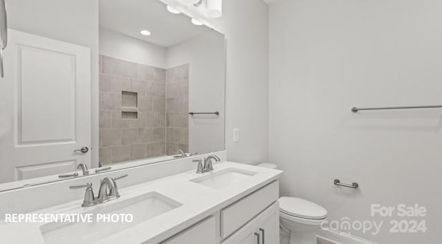 bathroom featuring toilet and vanity