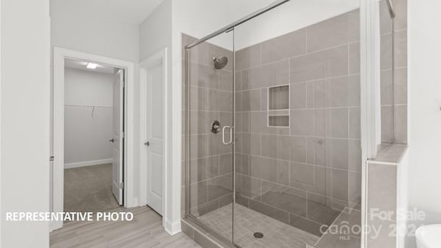 bathroom featuring a shower with shower door