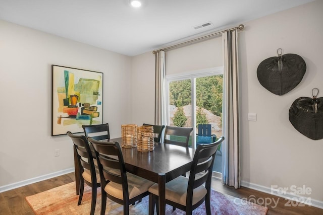 dining space with dark hardwood / wood-style floors