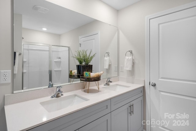 bathroom featuring walk in shower and vanity