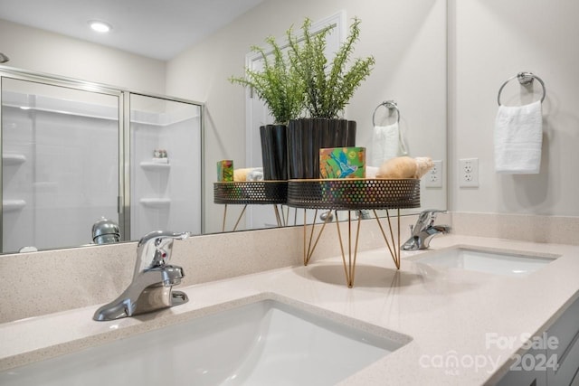 bathroom featuring walk in shower and vanity