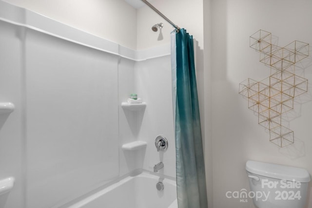 bathroom with toilet and shower / bath combination with curtain