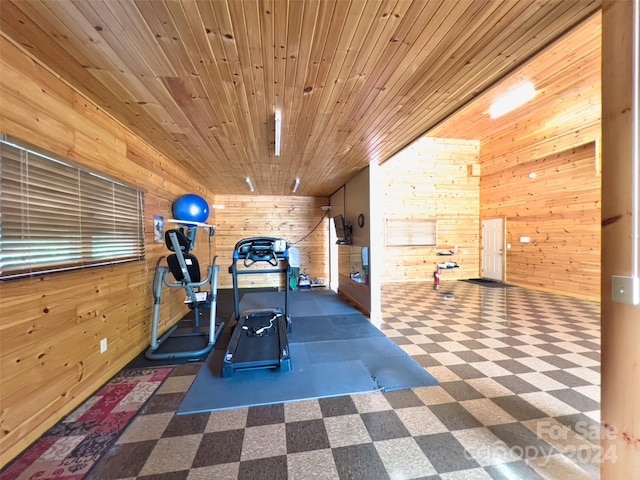 exercise area featuring wood ceiling and wooden walls