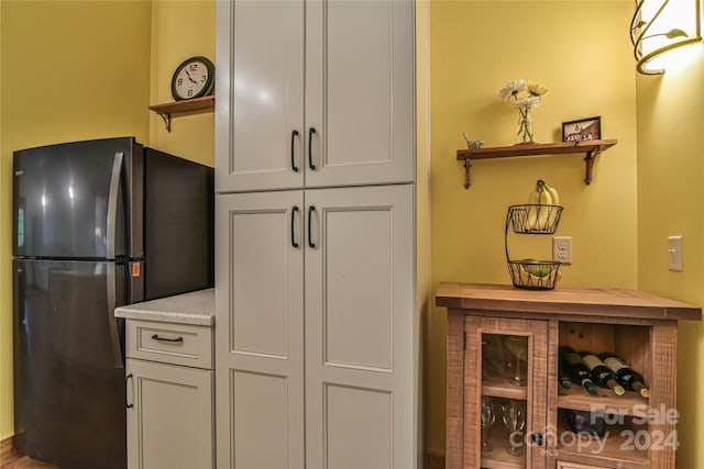 kitchen featuring white cabinets and refrigerator