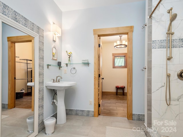 bathroom featuring tile patterned flooring and tiled shower