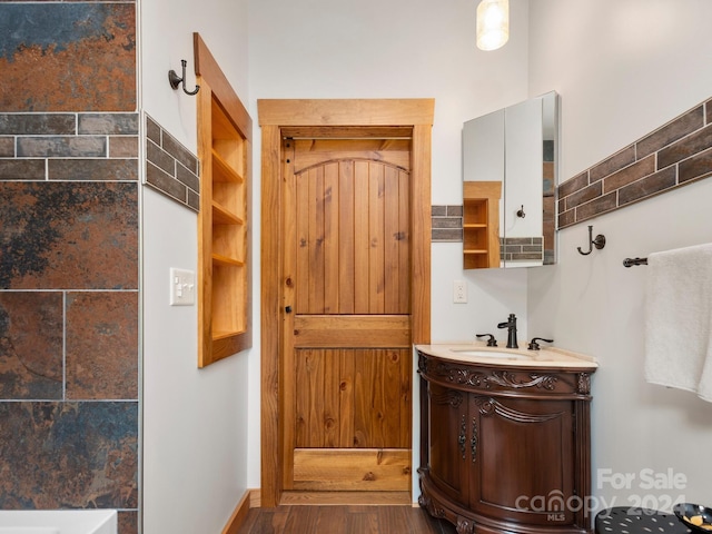 bathroom with vanity and hardwood / wood-style floors