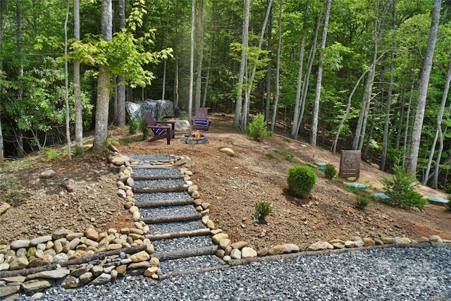 view of yard featuring an outdoor fire pit