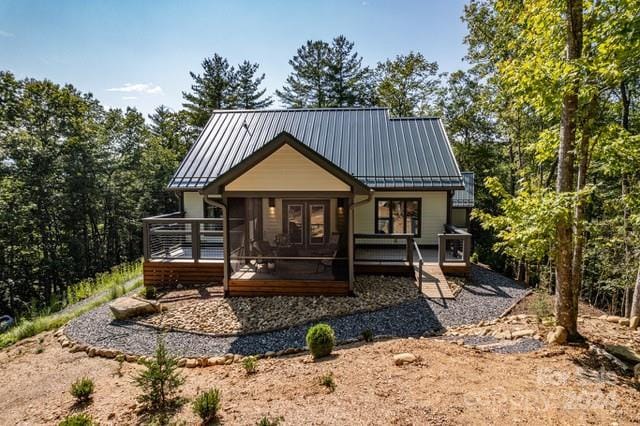 back of house with a deck and a sunroom