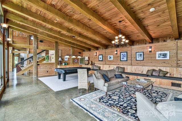 living room with an inviting chandelier, wood ceiling, wooden walls, and lofted ceiling with beams