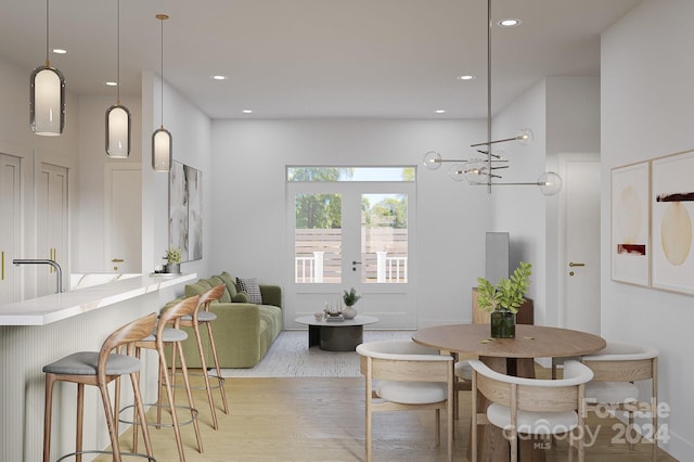 dining space with light wood-style floors and recessed lighting