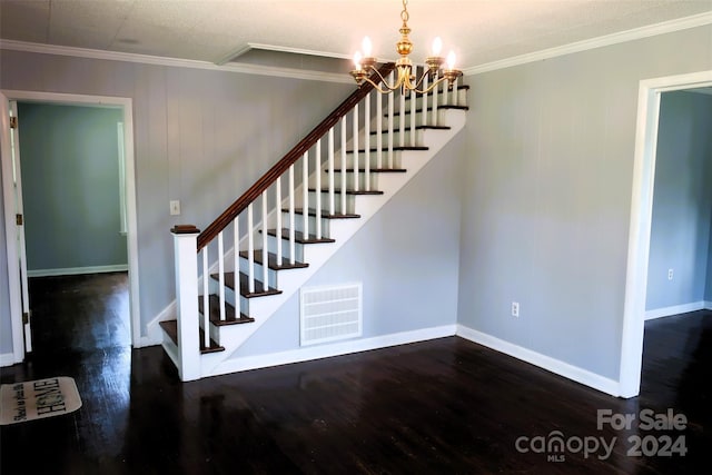 stairway featuring an inviting chandelier, crown molding, and hardwood / wood-style floors