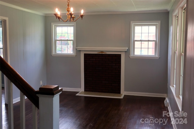 interior space featuring dark hardwood / wood-style flooring, crown molding, and a chandelier