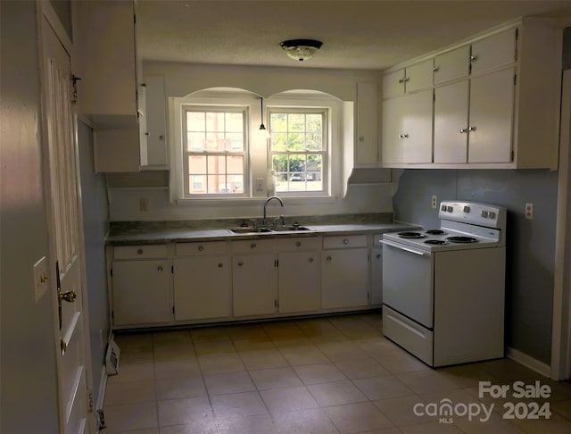 kitchen featuring white cabinets, white electric range oven, sink, and light tile patterned floors