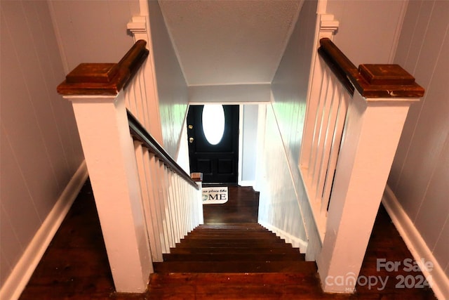 staircase with hardwood / wood-style floors