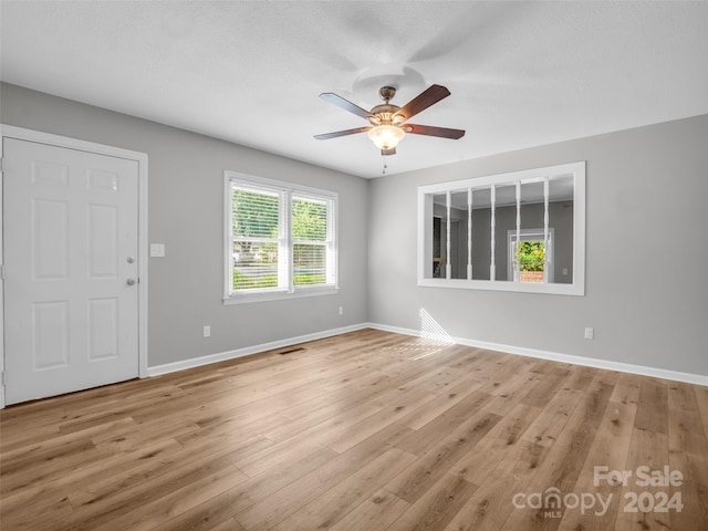 spare room featuring ceiling fan and light hardwood / wood-style flooring