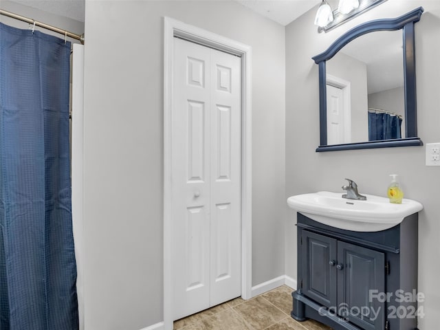 bathroom with tile patterned floors and vanity