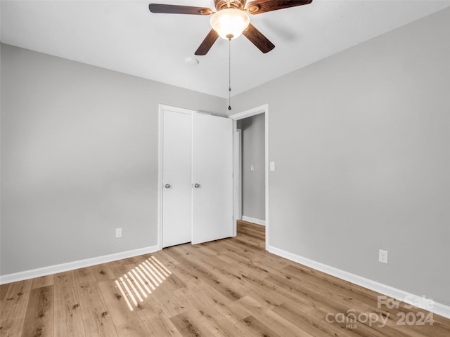 unfurnished bedroom with ceiling fan and light wood-type flooring