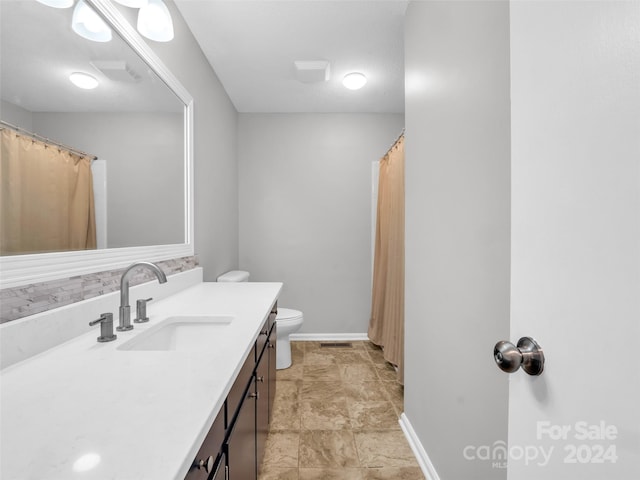 bathroom featuring toilet and vanity