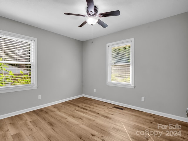 unfurnished room with ceiling fan, plenty of natural light, and light hardwood / wood-style flooring