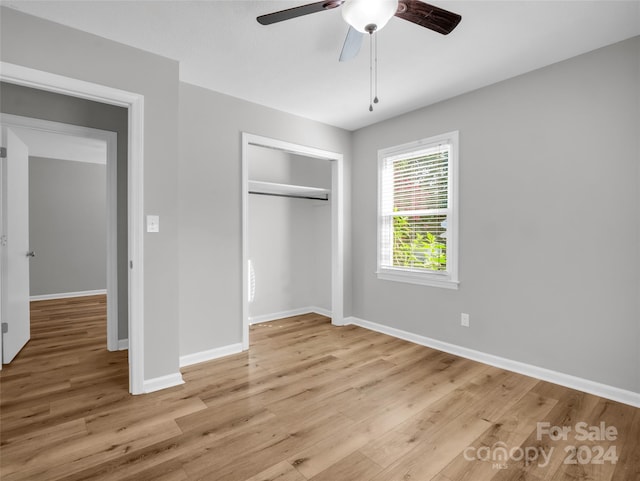 unfurnished bedroom with ceiling fan, a closet, and light hardwood / wood-style flooring