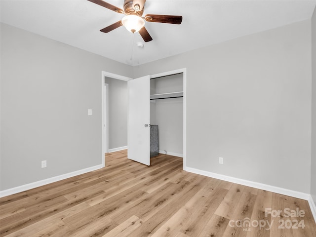 unfurnished bedroom with ceiling fan, a closet, and light wood-type flooring