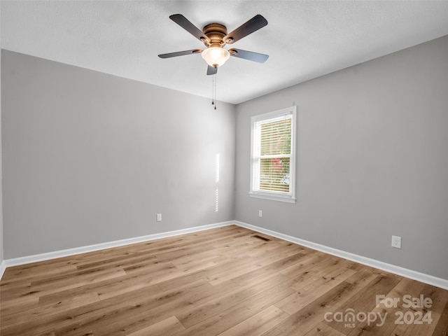 spare room with ceiling fan and light hardwood / wood-style flooring