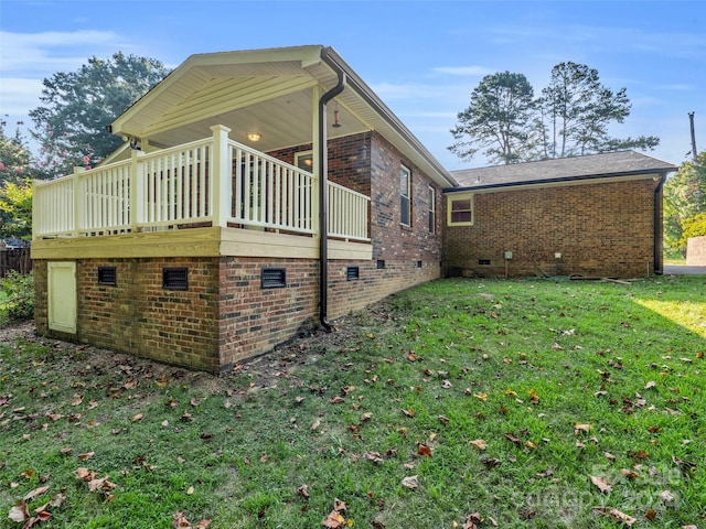 view of home's exterior with a wooden deck and a lawn