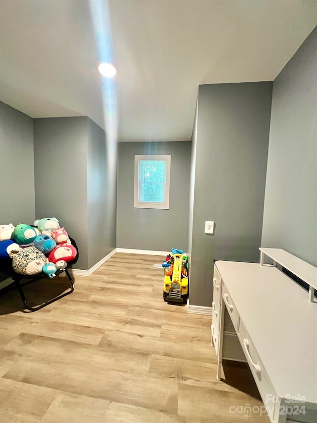 game room with light hardwood / wood-style flooring