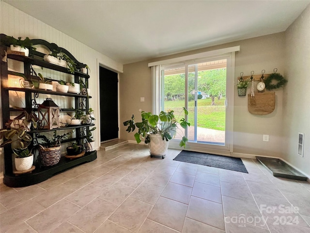 doorway with light tile patterned floors