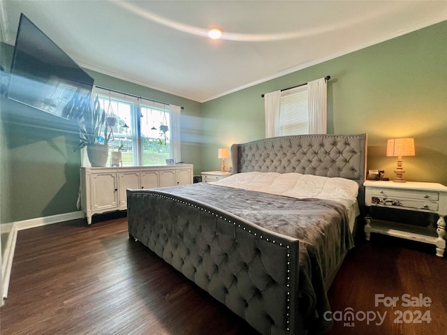 bedroom featuring dark wood-type flooring and crown molding