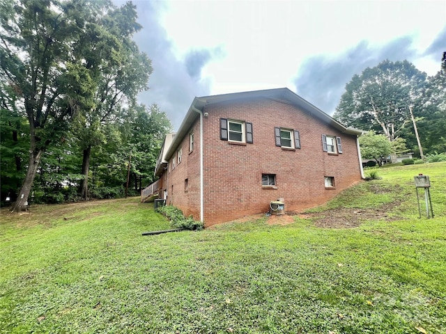 view of side of home with a lawn