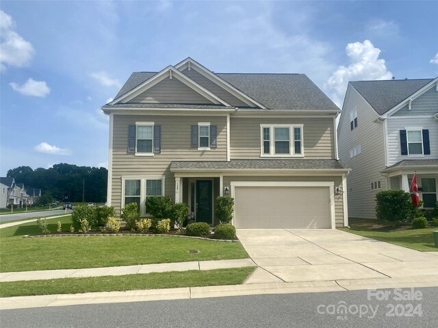 view of front facade with a garage and a front yard