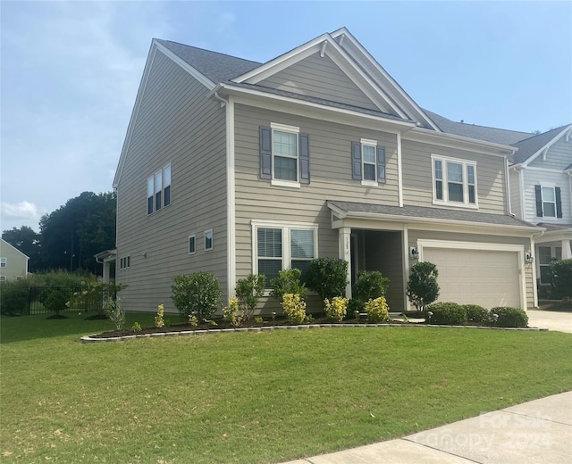 view of front facade featuring a garage and a front lawn