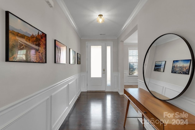 foyer entrance featuring crown molding and dark hardwood / wood-style floors