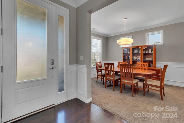 dining area featuring dark hardwood / wood-style flooring and ornamental molding