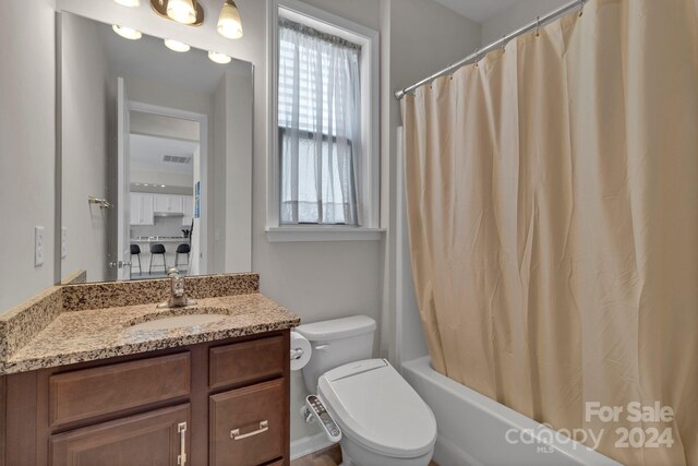 full bathroom featuring vanity, toilet, shower / bath combo, and plenty of natural light