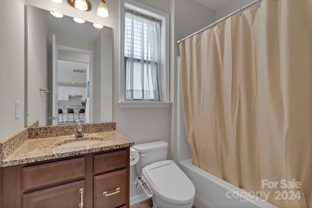 full bathroom with vanity, toilet, and shower / bath combo with shower curtain