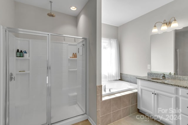 bathroom featuring tile patterned flooring, vanity, and independent shower and bath