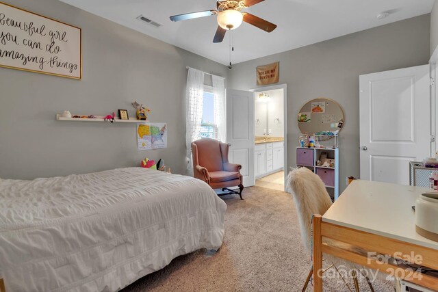 bedroom with light carpet, ceiling fan, and connected bathroom