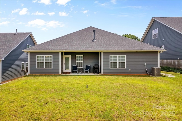 rear view of property with a lawn and central AC unit