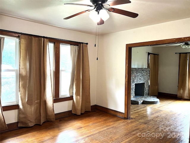 interior space featuring a fireplace, a healthy amount of sunlight, and light wood-type flooring